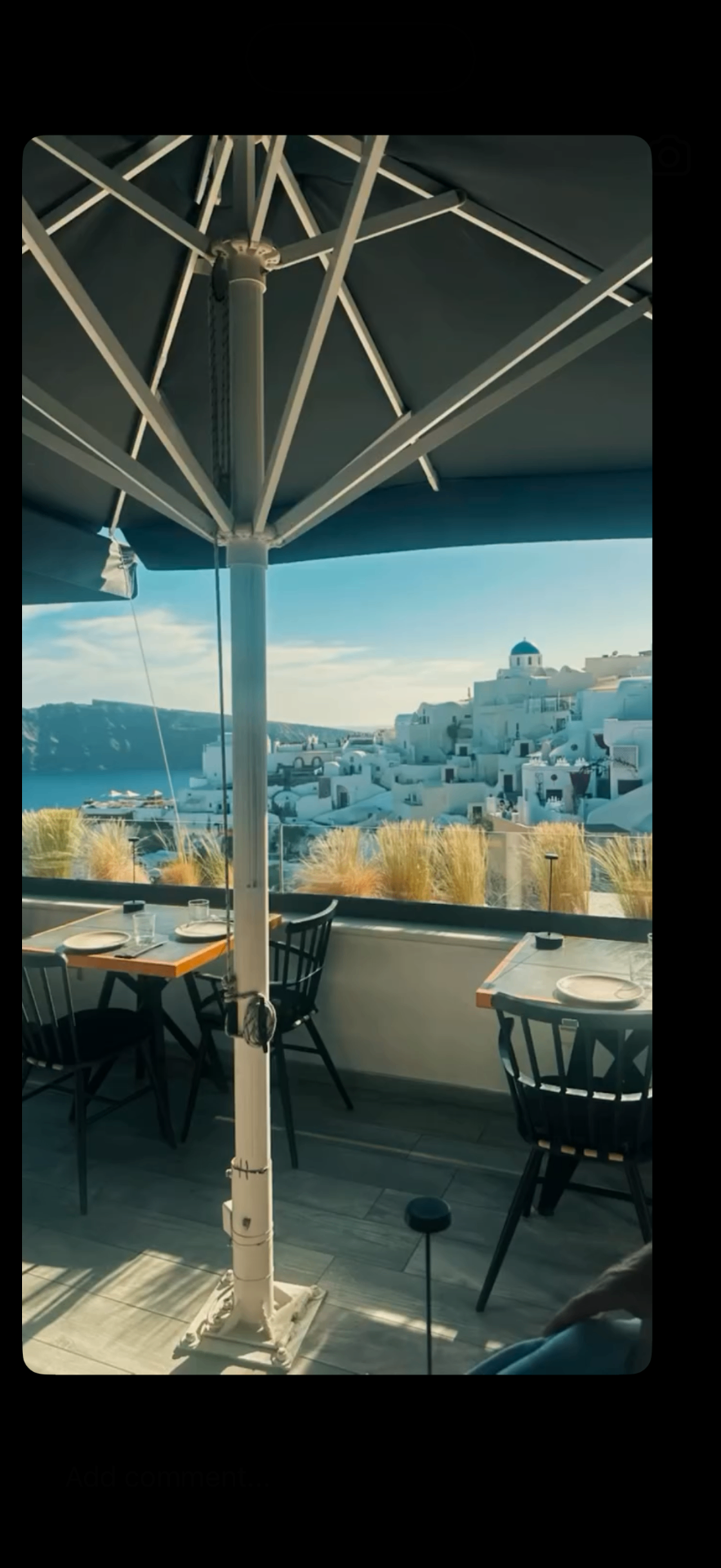 Restaurant terrace overlooking the whitewashed village of Oia, Santorini